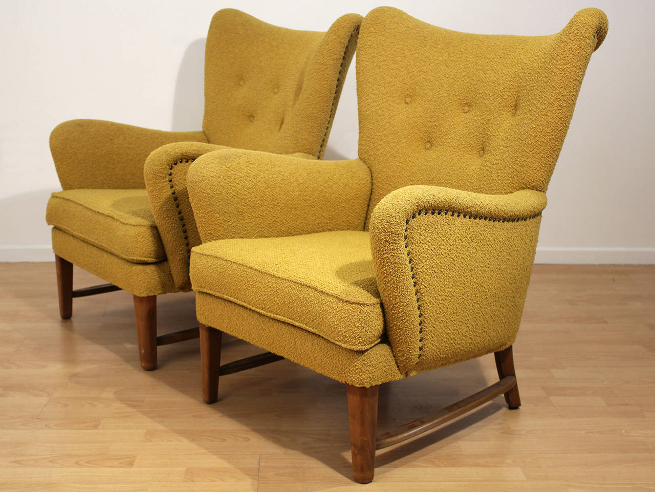 An exceptional pair of early modernist wing back armchairs. Matching sofa also available. This entire set is in amazingly well preserved all-original condition with original finish and nubby mustard upholstery. Minor wear considering the age. Very