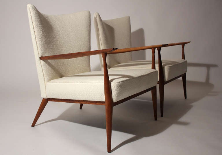 Classic pair of lounge chairs designed by Paul McCobb for Directional. Sculptural walnut frame with pearl bucle fabric. Completely restored.