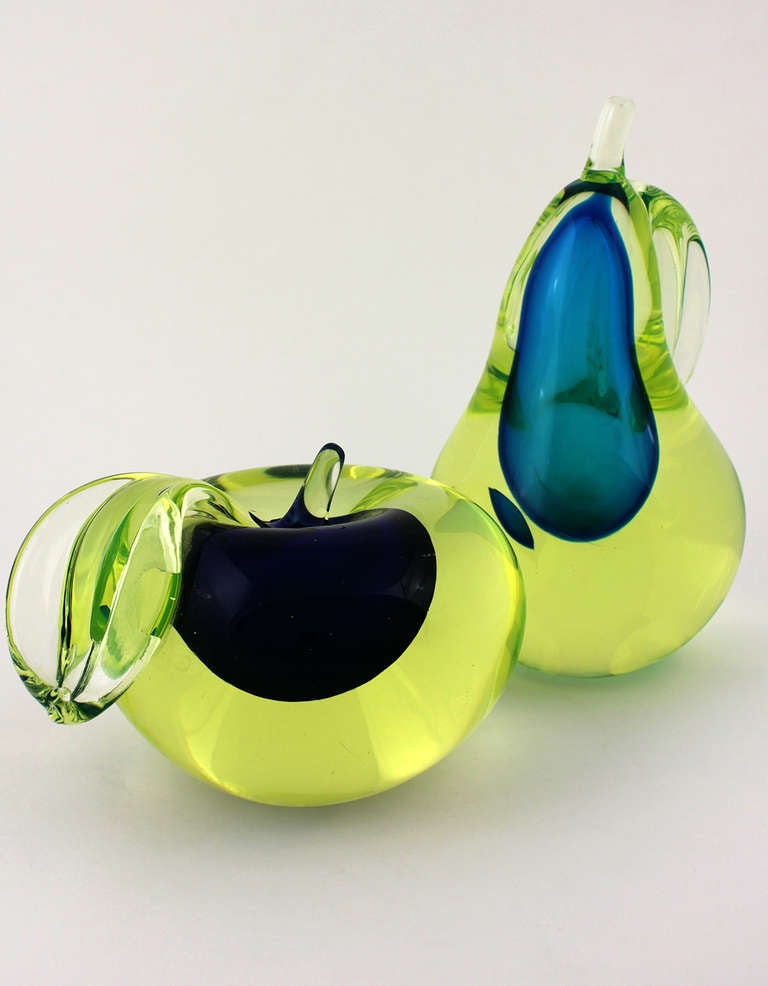 Pair of Gino Cenedese Murano glass bookends. One pear, one apple, each with light green colored glass. One with dark puple and the other medium blue interior meltings.

One measuring 9