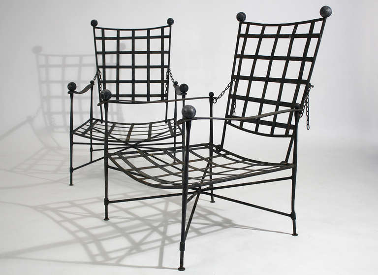 Mario Papperzini designed for John Salterini pair of wrought iron adjustable lattice back lounge chairs for indoor or outdoor use. This pair has been kept in its original vintage and aged condition.