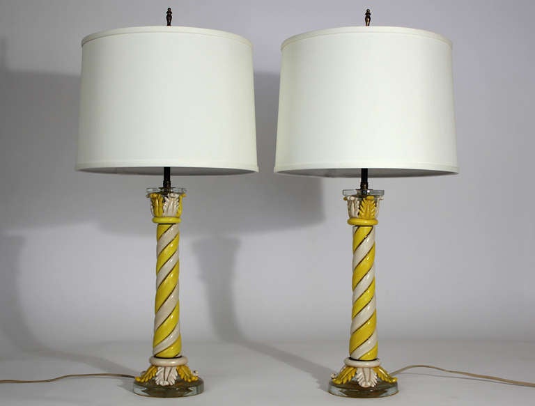 Pair of unusual and early Murano table lamps with twisted pillar columns of ivory and yellow colored glass, original finials and double bulb clusters. Excellent original condition.

5.5