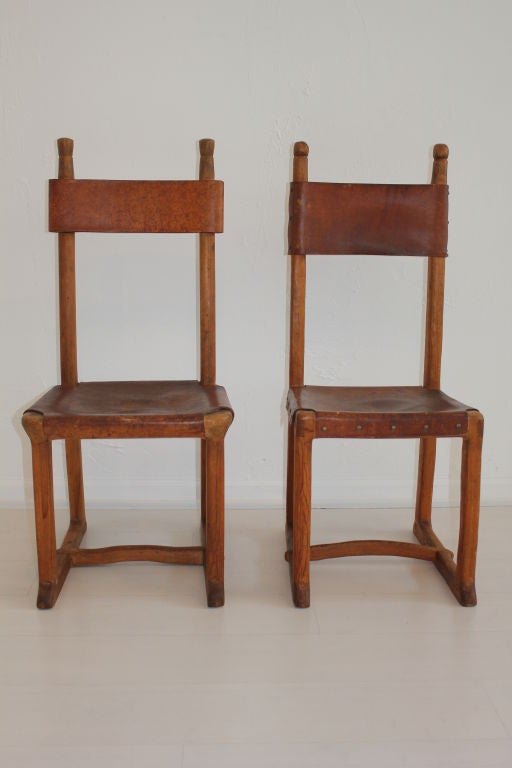 Pair of rare hand crafted pine and leather chairs by Ben Wade. These are two of a very limited number of pieces made by Wade for a Taos, New Mexico adobe. They are very close in size but crafted with some unique differences. Both hold the Ben Wade