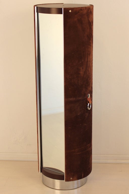 Dark brown suede wardrobe designed by Guido Faleschini in 1974. It was produced by Mariani exclusively for the Pace Collection. This piece is on a spinning base for hidden clothes storage and has a full length mirror on the front.