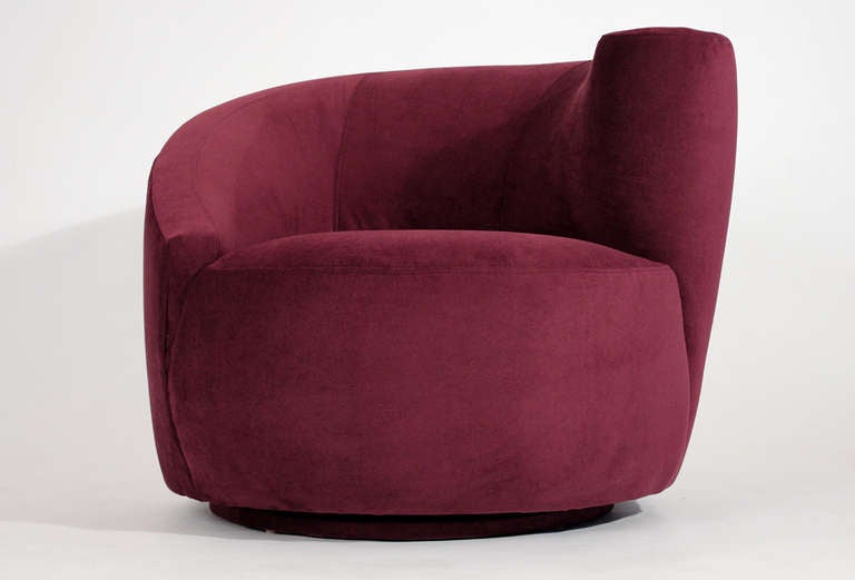Nautilus lounge or club chair on swiveling base designed by Vladimir Kagan for Directional Furniture upholstered in a plum red velvet fabric.