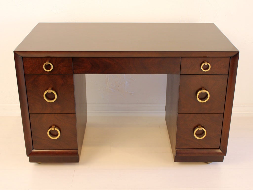 Beautiful seven drawer desk with solid brass pulls designed by T. H. Robsjohn Gibbings for Widdicomb. Finished on all sides to be placed to be placed in the middle of a room as well as against a wall.