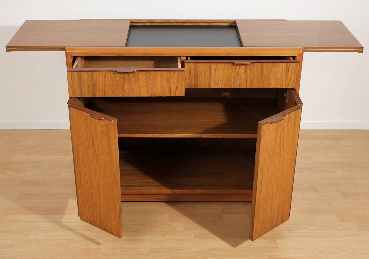 Expandable top dry bar with rosewood handles by Drexel. Top measures 60