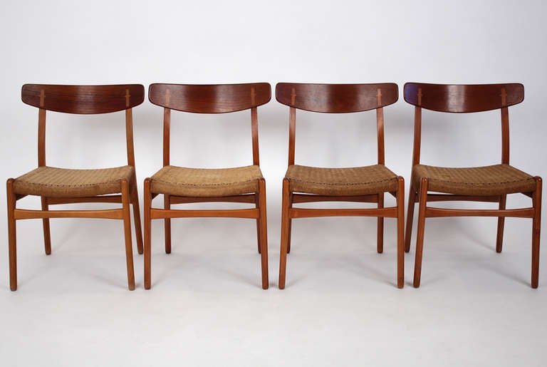 Set of 4 Hans Wegner for Carl Hansen CH-23 solid teak dining chairs with original cord seats. Designed in 1951.