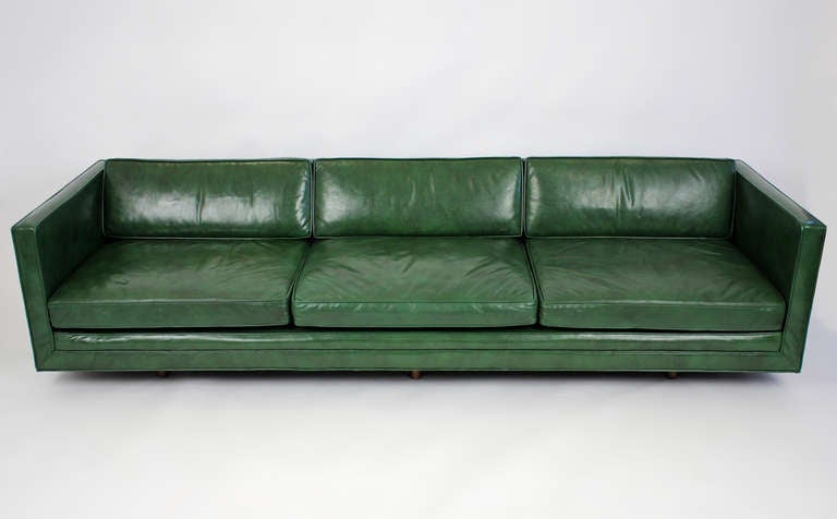 Tuxedo sofa with all original dark green leather upholstery designed by Harvey Probber. Circa early 1950s.