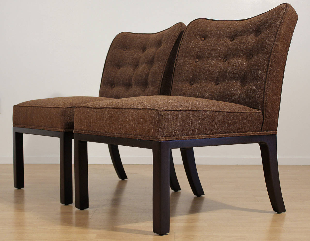 Pair of side upholstered side chairs by Edward Wormley for Dunbar. Medium brown lightly textured fabric and dark brown lacquered wood base. Chairs have been completely redone.