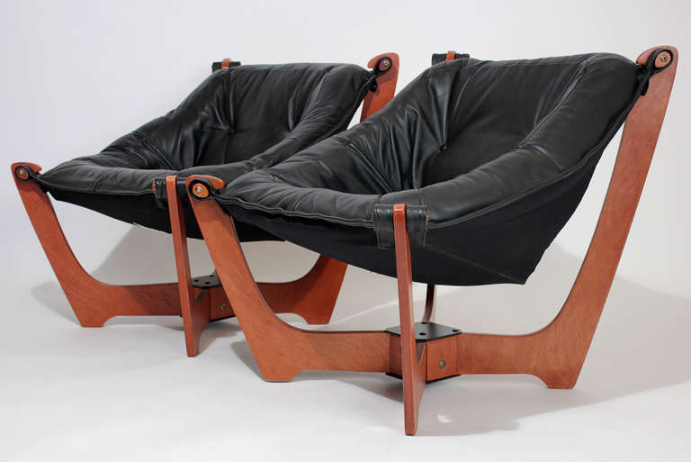 Pair of Norwegian lounge chairs with padded leather slung seats on wood bases. Slightly smaller in scale and very comfortable.