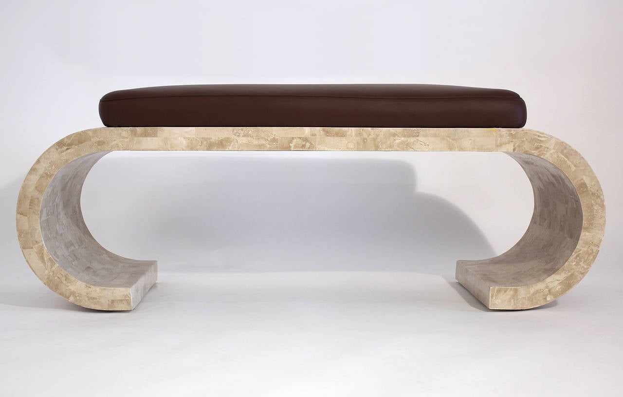 An elegant and simple scroll bench of tessellated stone with newly finished dark brown leather seat top in the manner of Karl Springer or Maitland-Smith. Overall measurements below. Actual seat measures 18