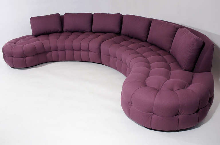 A wonderful and large 1970s curved sofa sectional with a deep tuft upholstered in a soft lavender colored, lightly textured fabric. In the manner of Harvey Probber or Billy Haines.

Overall depth: 66