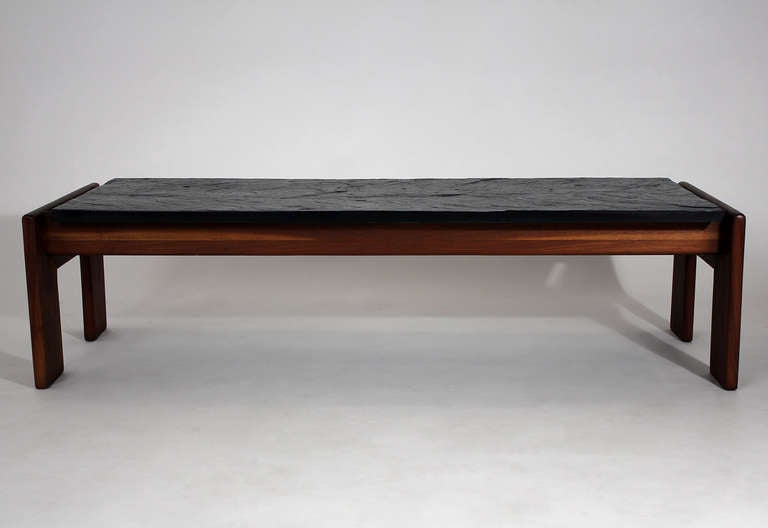 A beautifully crafted Mid-Century Modern coffee or cocktail table with riven slate textured top and solid walnut base.