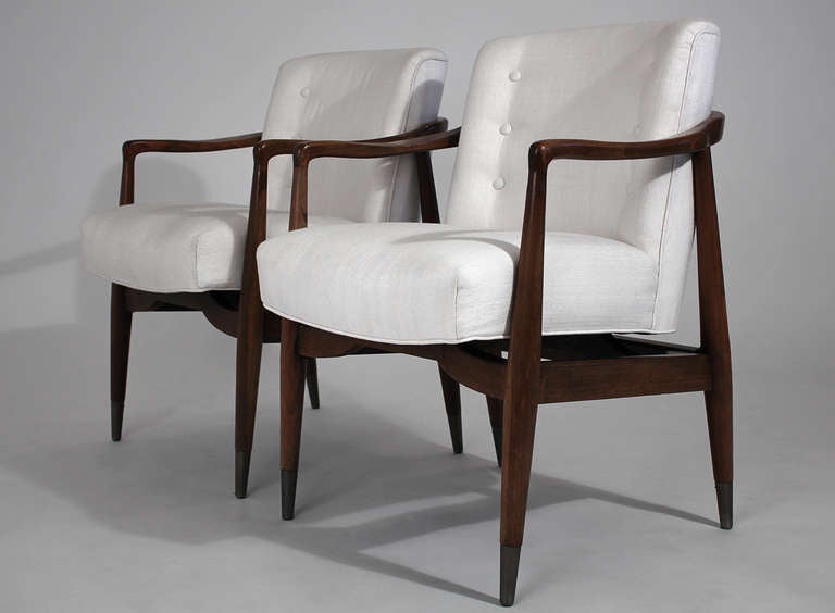 An elegant pair of solid wood arm chairs with white upholstered seats by Monteverdi-Young.