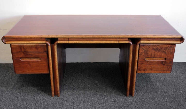 Extraordinary custom made executive desk by California craftsman Lou Hodges in an interesting mix of Walnut, Oak and Koa woods. Beautiful graining throughout. Circa 1960s.

This piece has been completely restored and is in excellent condition with