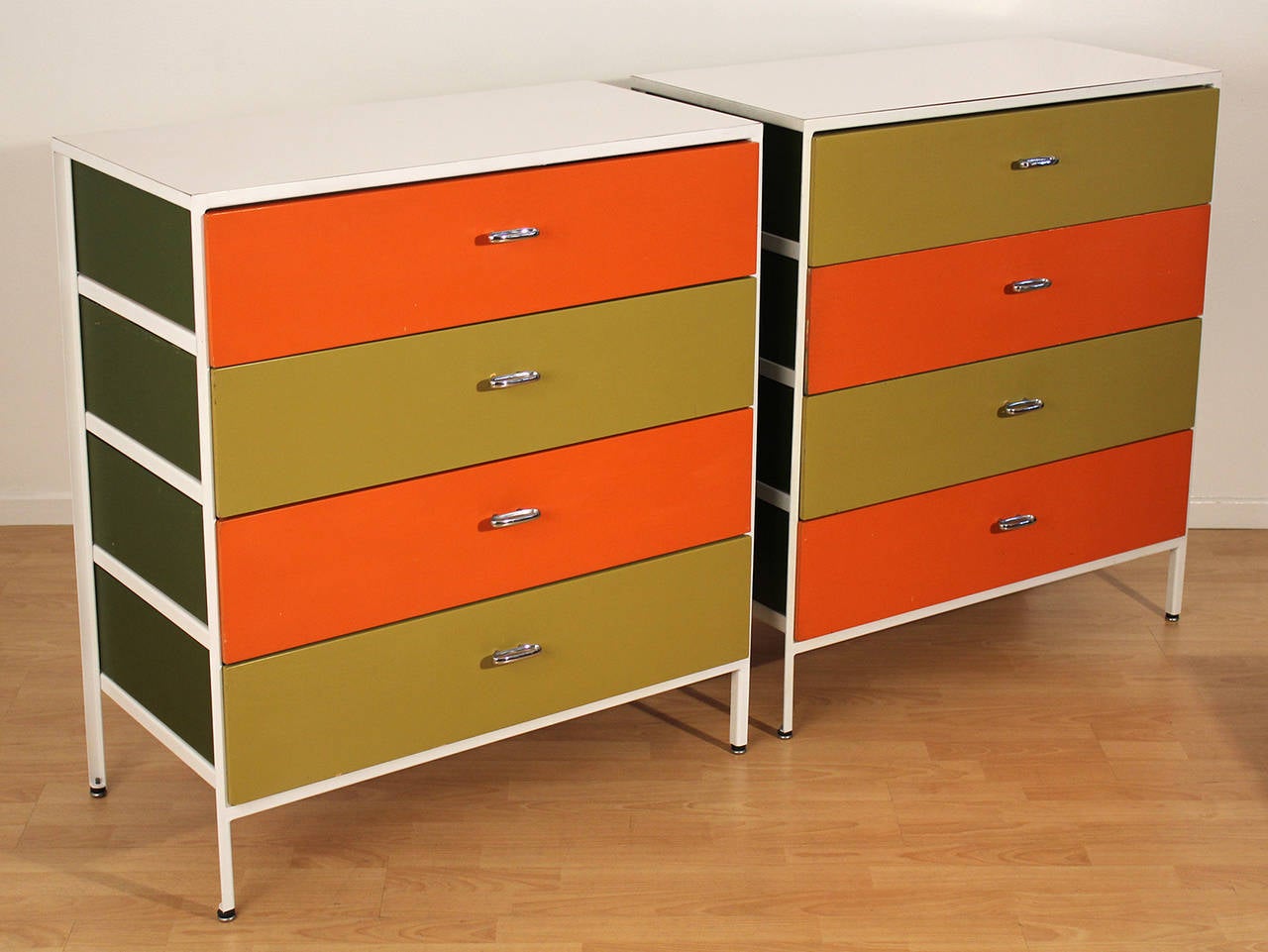 Prime examples of a vintage pair of dressers or chest of drawers designed by George Nelson for Herman Miller in a very uncommon four-drawer configuration with extraordinary color combination.

Completely original and unrestored throughout. Very