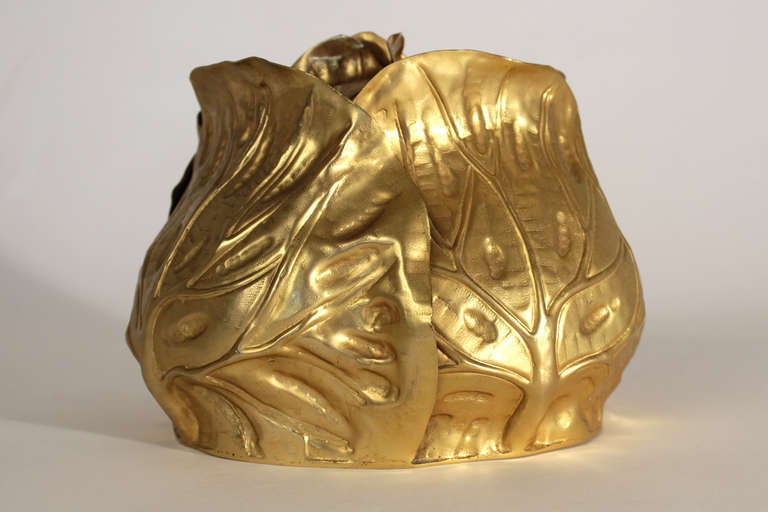 An interesting and unusual cabbage shaped and gold plated metal ice bucket with glass insert.