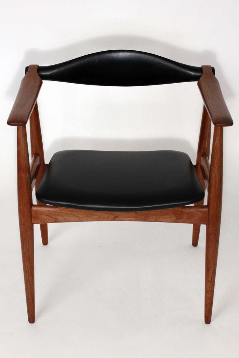 Black leather and teak frame example of this iconic design by Hans Wegner. Original black leather seat back in excellent condition with very minor wear consistent with age. Seat bottom recovered in appropriate leather.