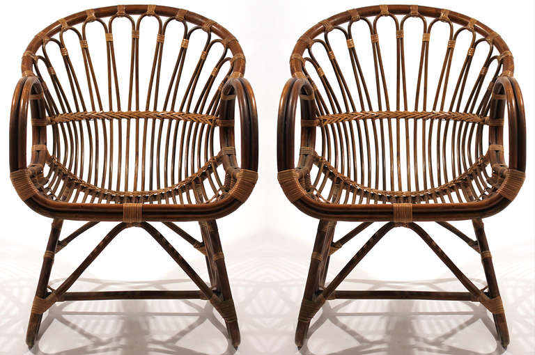 A pair of expertly constructed rattan lounge chairs in excellent condition showing only age appropriate wear.