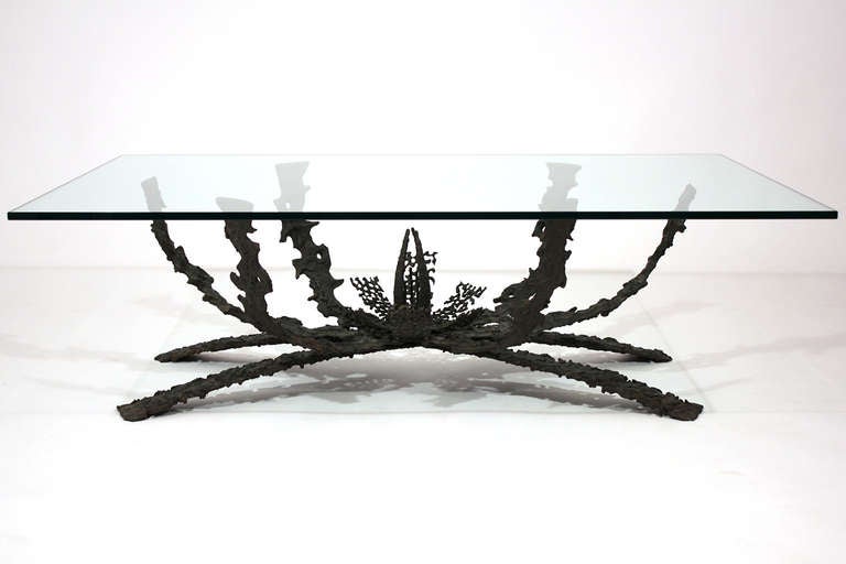 Brutalist sculptural bronze coffee or cocktail table with rectangular glass top by Daniel Gluck. Glass top measures 48