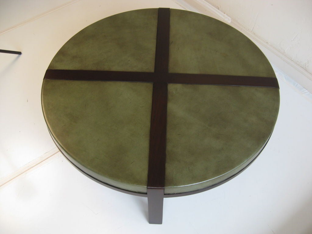 Cocktail table designed by Tommi Parzinger for Charak Furniture. The table is wrapped in distressed green leather with lightly tooled edges.