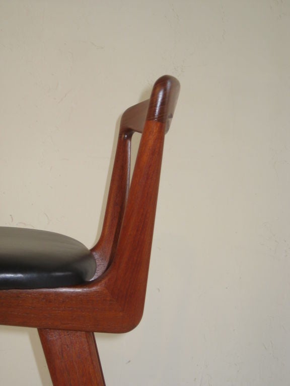 Beautiful sculptured solid teak wood construction. Seats have been reupholstered in black lambskin leather. The stools were designed by Henry Rosengren Hansen for Brandt Mobelfabrik.