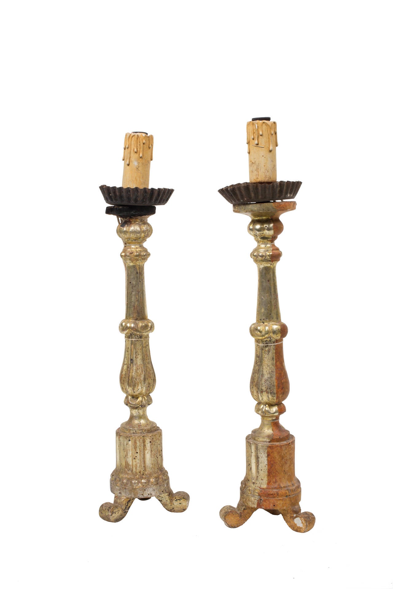 Pair of antique candlesticks with beautiful original gild from Italian altar. Front sides are gilded with original wood exposed at back for altar setting. Cork and wood like material legs show damage.

Wear consistent with use and age. Gild has