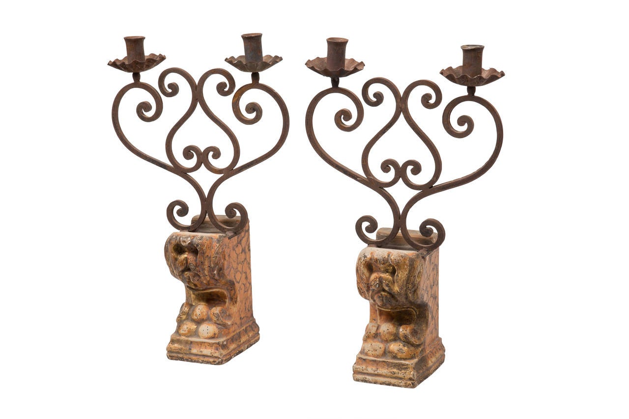 19th century Italian gilded wood foot with iron two-light pair of candelabras.
