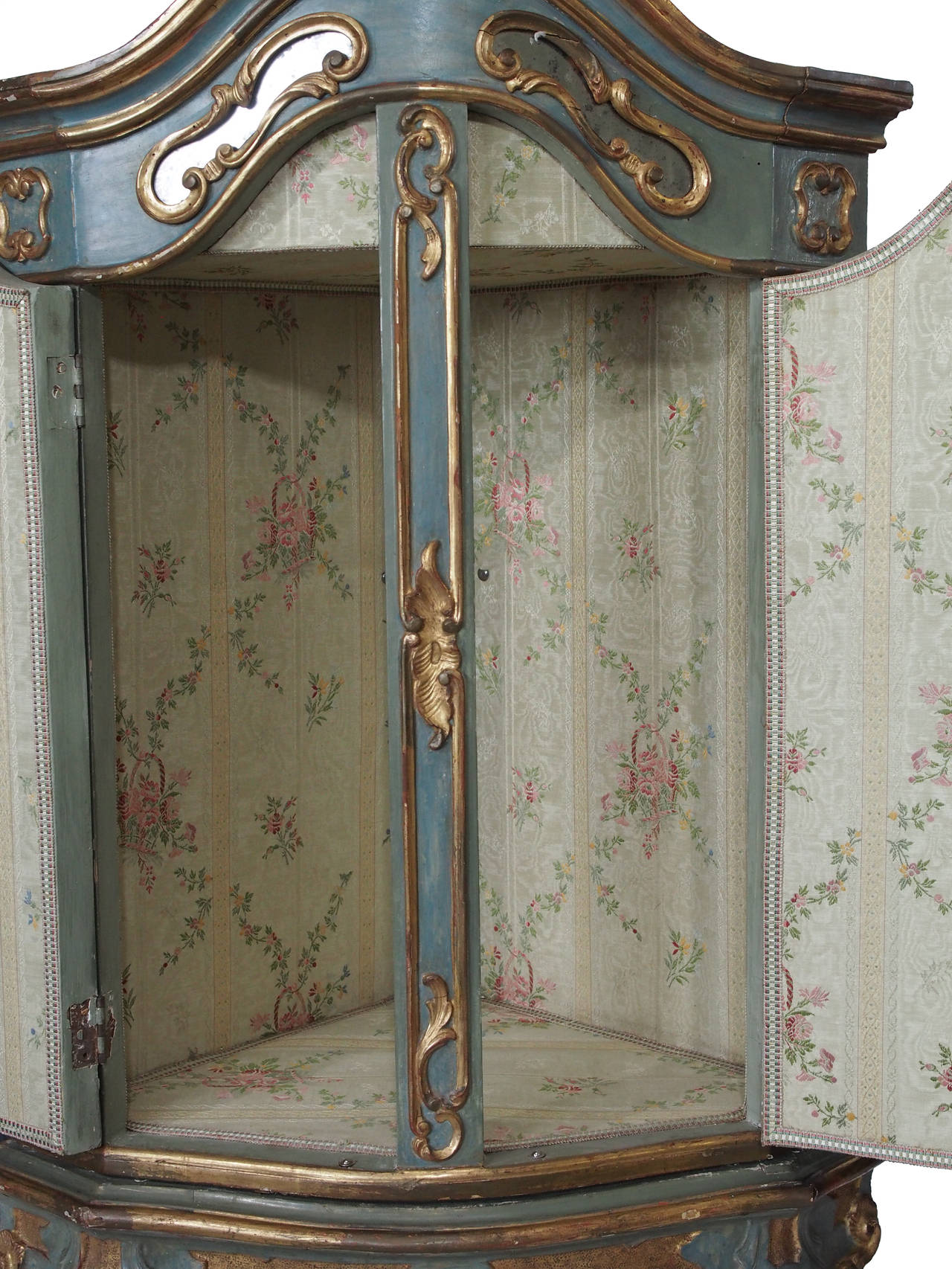 Exquisitely carved and lacquered corner cabinet on detailed legs. Mirrored doors open into charming upholstered interior. Lovely jewel box addition to a fanciful room