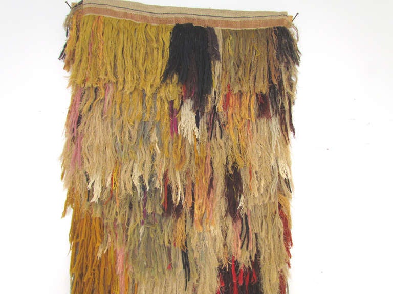 Impressive 7 foot tall wall hanging of individually woven, feathery  
strands of various  natural and dyed fibers. This piece is a  
breathtaking example of the freeform Fiber Art Movement of the  
1960s-70s. With a handwoven Navajo style weaving
