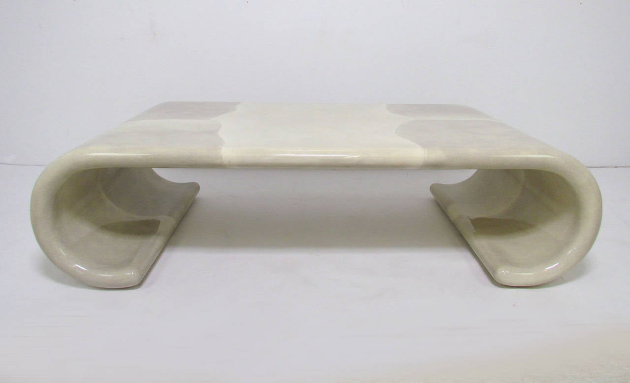 Scroll form waterfall coffee table in lacquered faux goatskin, circa 1970s. In the manner of Karl Springer. Uncommonly found shades of grey and ivory make this a spectacularly versatile piece.