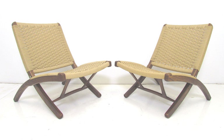 Pair of mid-century modern folding chairs in the manner of Hans Wegner.  Made in Japan.    Extraordinary level of craftsmanship.