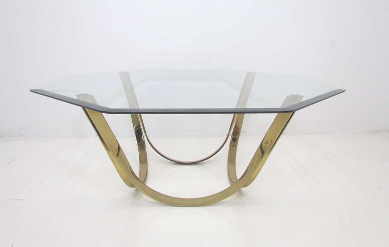 Coffee table with sculptural brass base of conjoined arches, beveled octagonal glass top, by Roger Sprunger for Dunbar, ca. 1970s.
