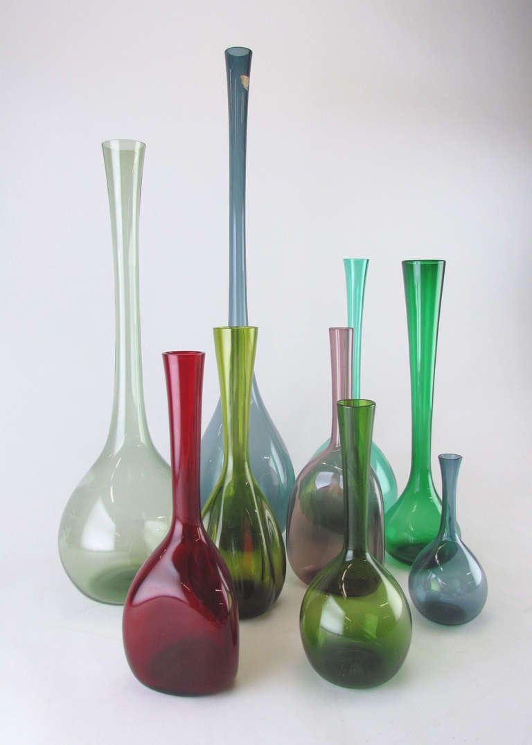 Delicate grouping of nine hand blown Swedish art glass vases, ca. 1960s, several of which were designed by Arthur Percy.  The largest still retains a partial Gullaskruf label and  measures 20.25