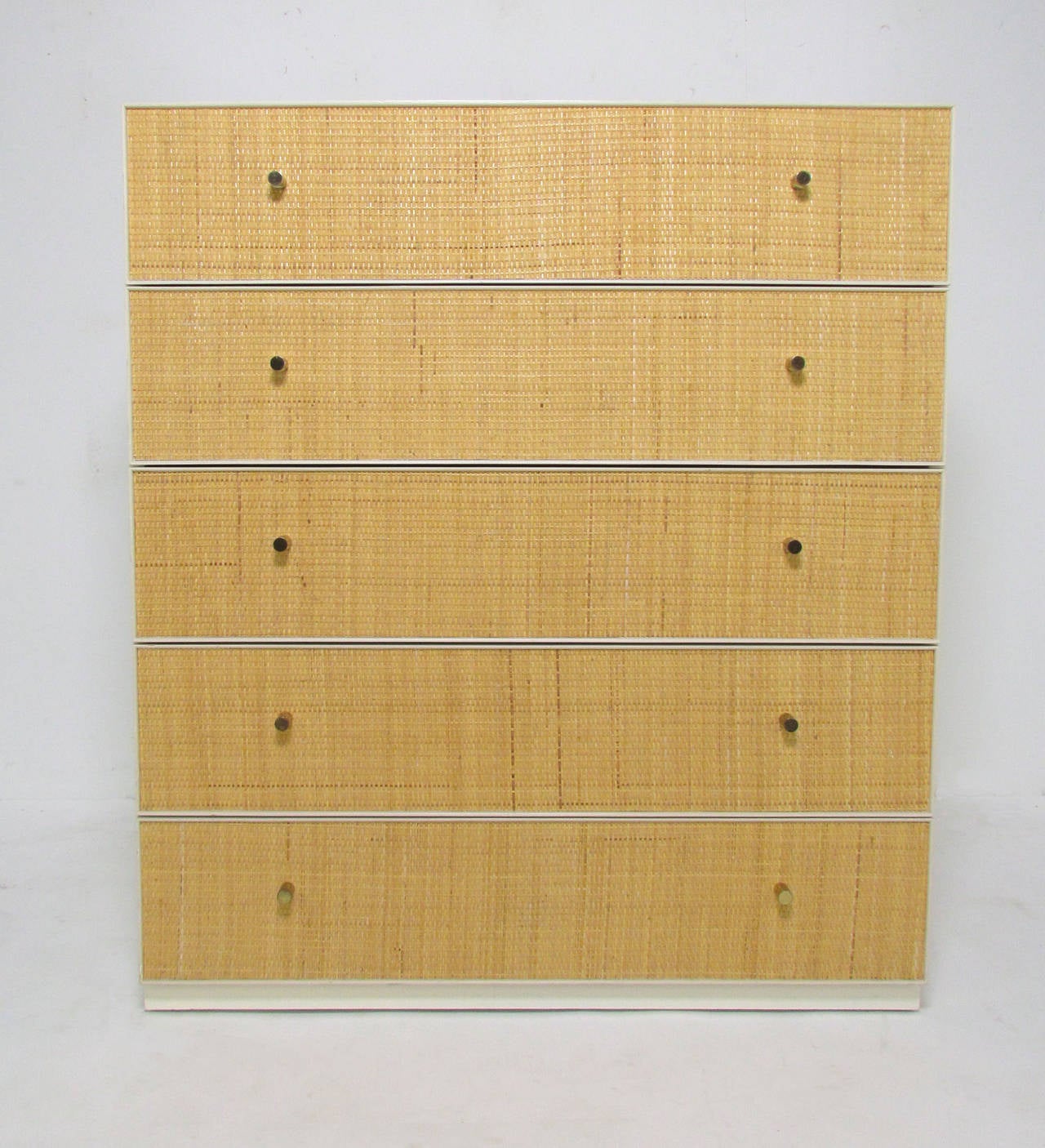 Five-drawer lacquered dresser with cane drawer fronts and brass pulls, labeled Directional, attributed to Harvey Probber, circa 1960s.