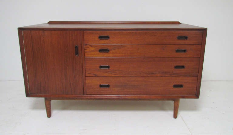Danish teak server sideboard (or buffet) designed by Arne Vodder, made by Sibast, Denmark, for George Tanier Selection. Feature's Vodder's signature carved back rail. Great size for an apartment or smaller dining area. 54