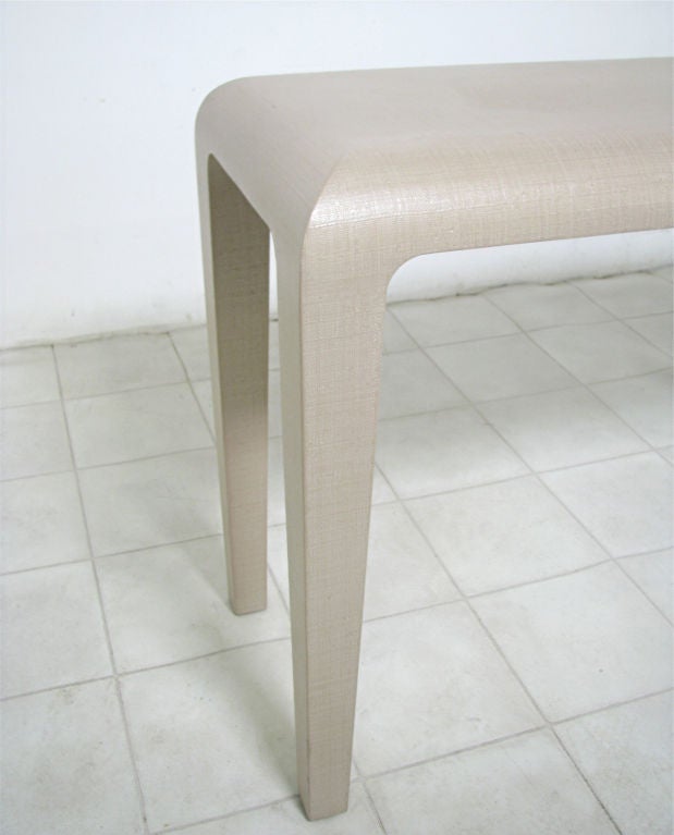 Elegant grass cloth console table with tapered legs by Harrison-Van Horn, ca.1980s, reminiscent of the designs of Karl Springer.