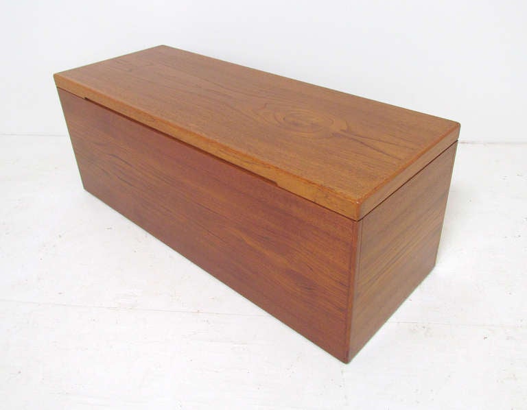 Large Danish teak blanket chest / storage trunk, finished interior with removable adjustable shelf.  Great size for end-of-bed storage, and great height for use as a seating bench or even as a coffee table.   On recessed casters.