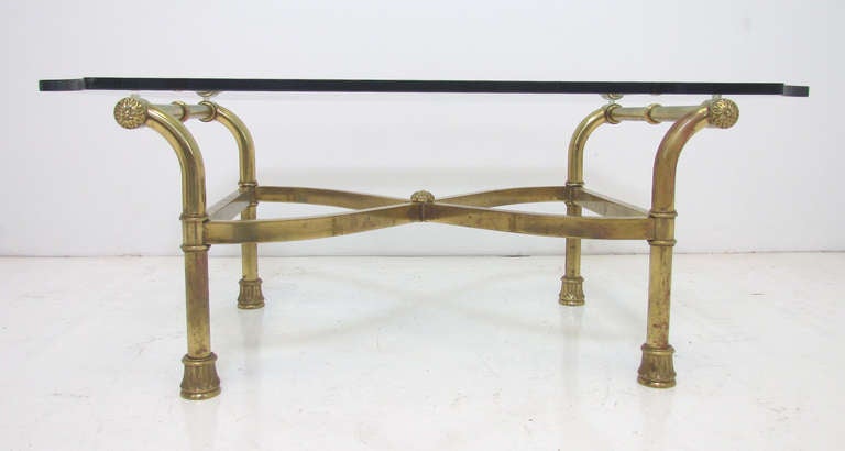 Hollywood Regency style scroll form coffee table in brass with beveled 1/2