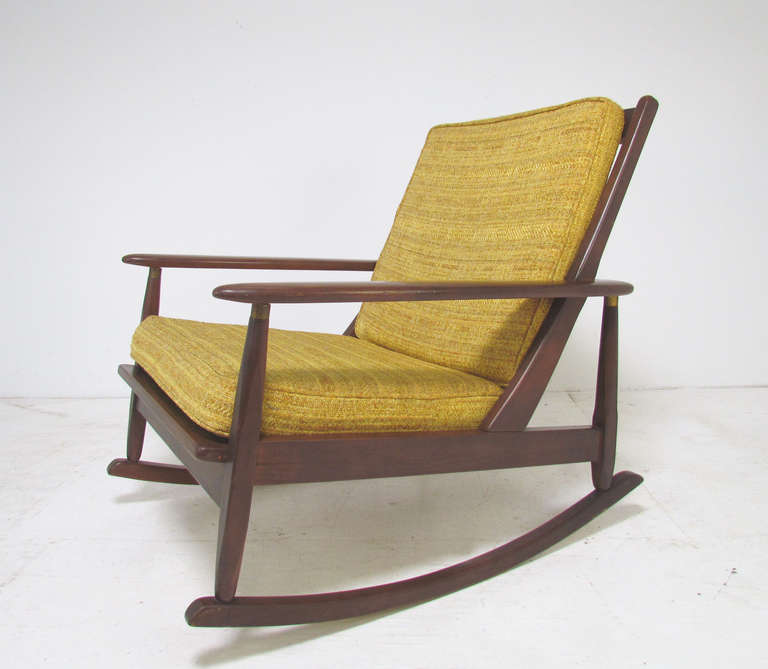 Classic low-slung mid-century American modern rocker with paddle arms,  circa 1960s.  Brass accents.