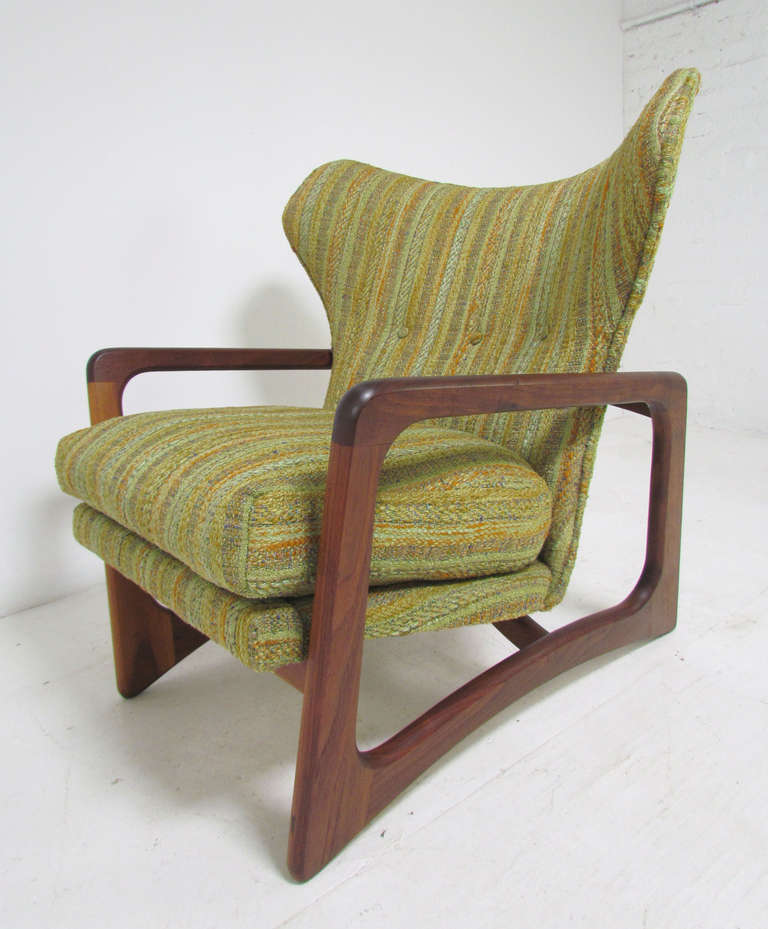 Mid-century lounge arm chair by Adrian Pearsall for Craft Associates, circa 1960s. Sculptural walnut framework, and exaggerated wing backs. Original upholstery and cushions in a remarkable state of preservation.