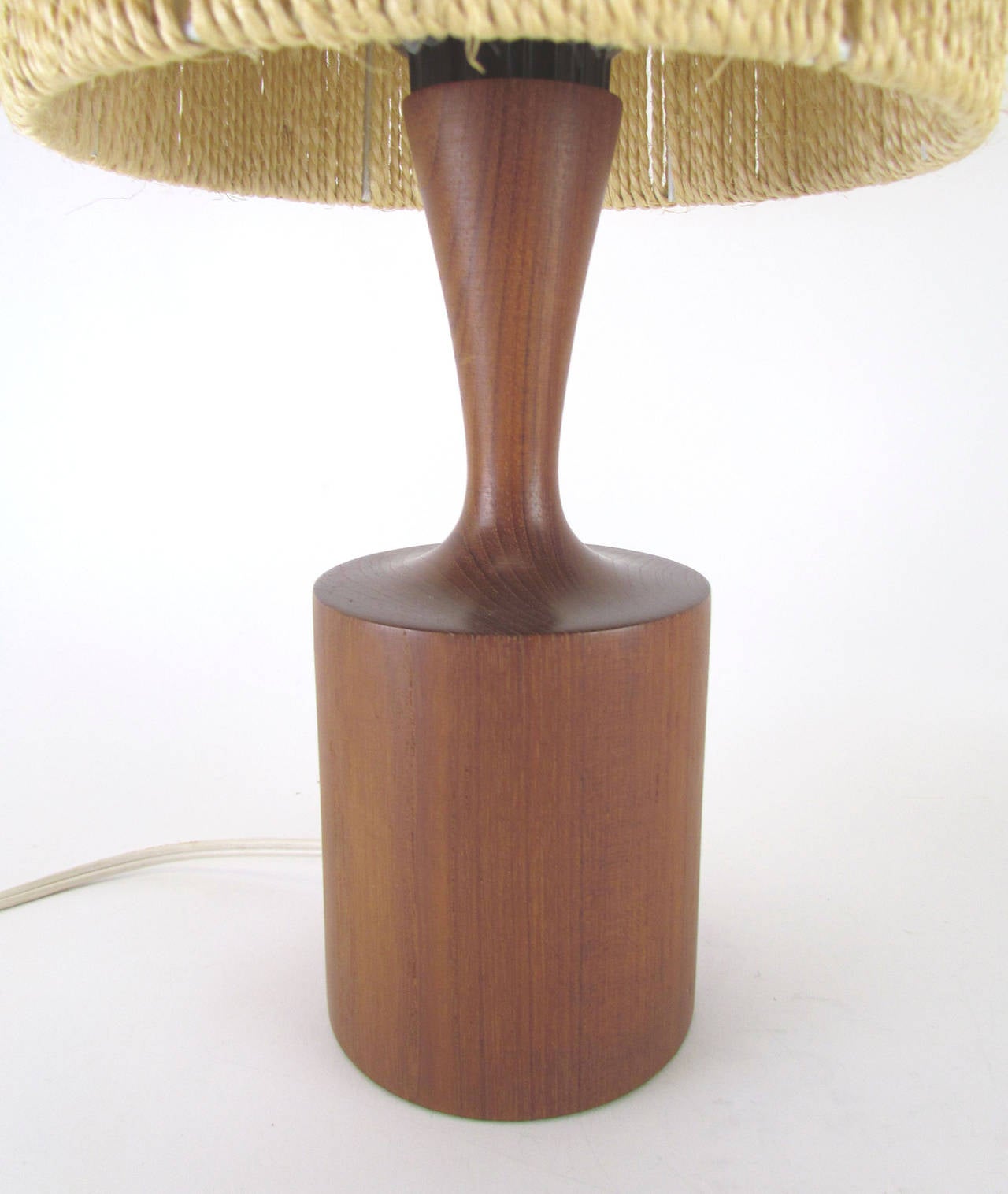 Accent table lamp with original jute cord shade and solid carved teak base by Danish lighting company Fog & Mørup, circa 1960s.

15.75