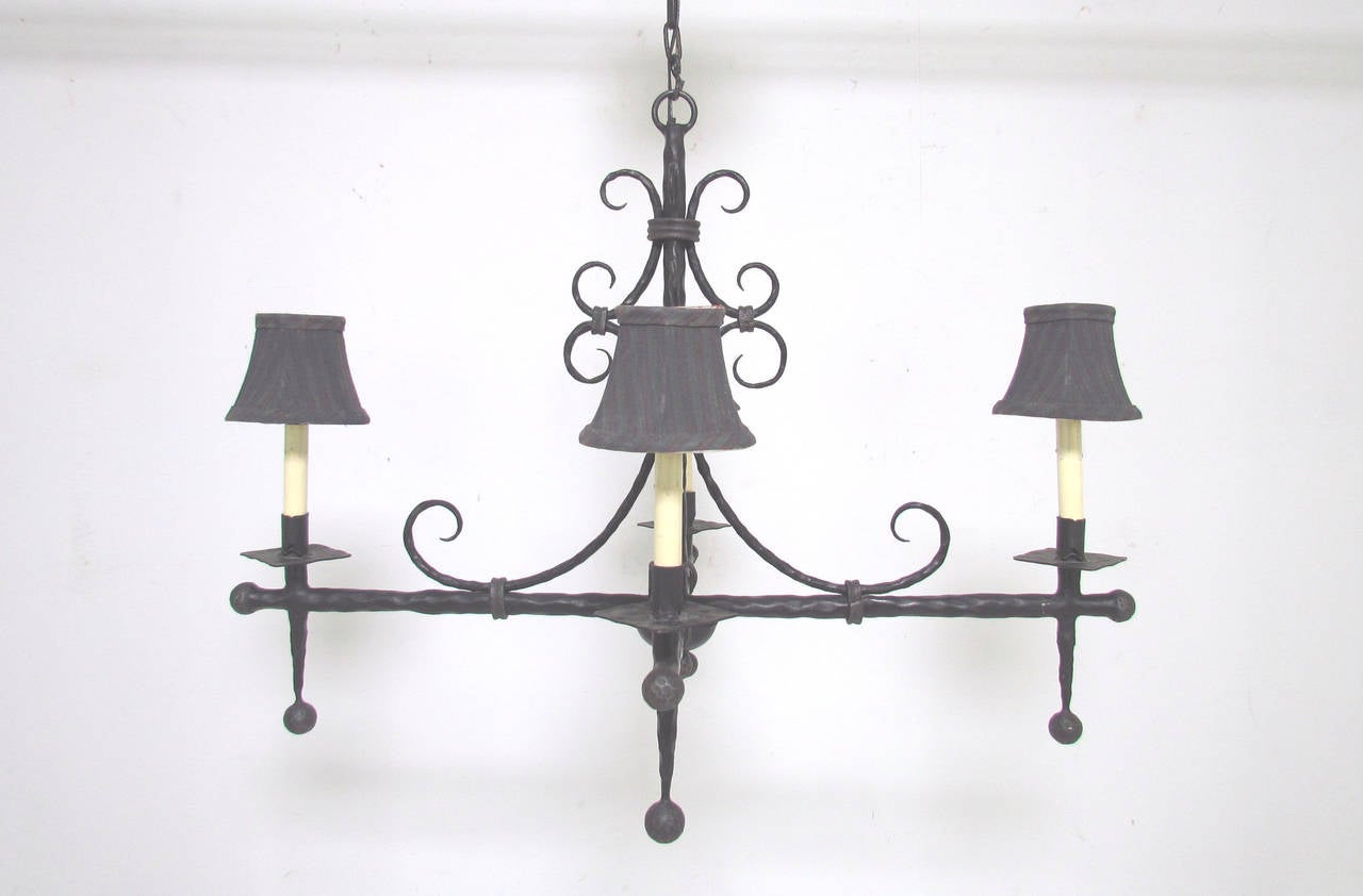 Majestic wrought iron four-light chandelier, marked Made in France, with faint, unknown maker's mark.

34