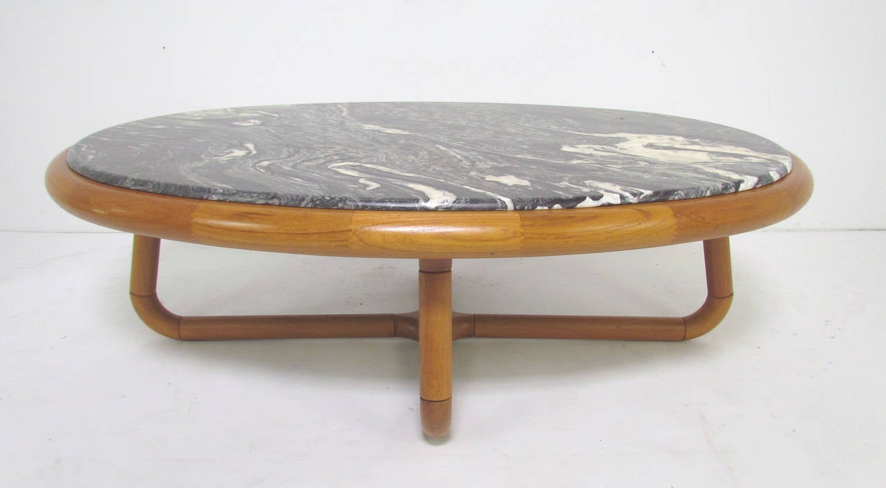 Danish teak coffee table with sculptural base and black zebra marble top. A transitional piece from the late 1970s, signed with label for the Danish Furniture Manufacturers' Association.