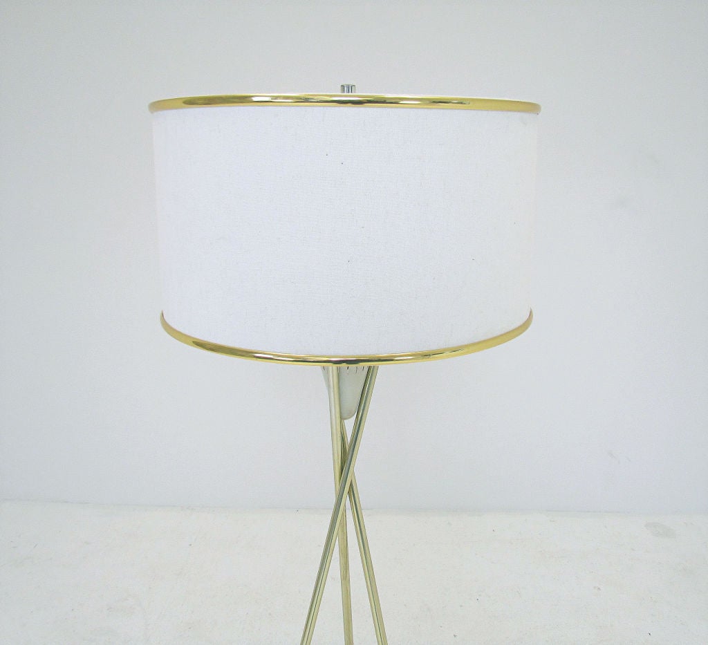 Tripod floor lamp in brass with walnut capped legs, ca. 1960s, attributed to Gerald Thurston for Lightolier.