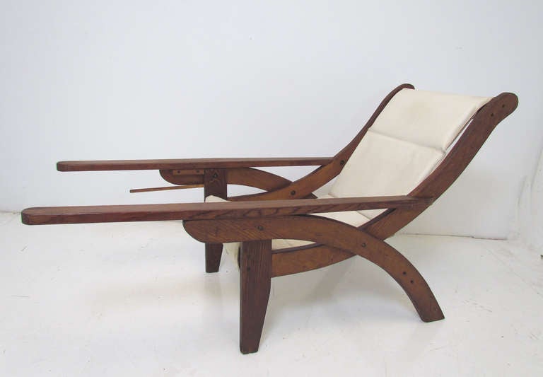 Exceptionally rare long paddle arm lounge chair modeled after the British Colonial Plantation style of the 19th century. Original sling seat and optional foot sling for reclining with intact peg for holding sling when not in use. A unique example of