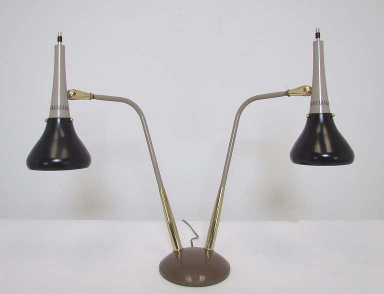 Classic Mid Century double arm lamp By Gerald Thurston for Lightolier, ca. 1950s.  Pivoting shades and arms.    

Measurements vary based on configuration. As shown in initial image, 22.75