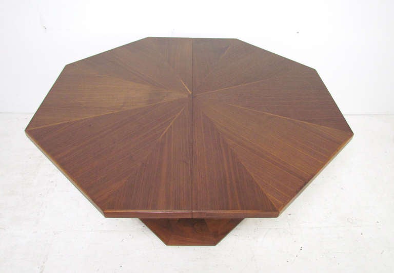 Octagonal dining table with inlaid top on a cut-out pedestal base, by Harvey Probber ca. 1960s.   With three book matched leaves, this table expands to 95.5