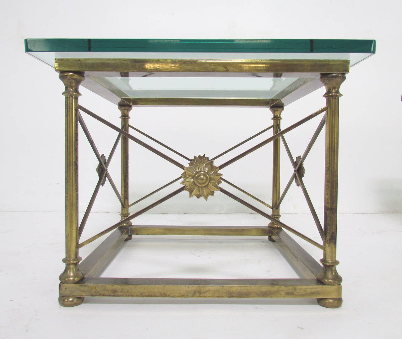 Pair of brass end tables by Mastercraft, made in Italy. Neoclassical-style medallions decorate all four sides. Lovely patina to the brass. Original 3/4