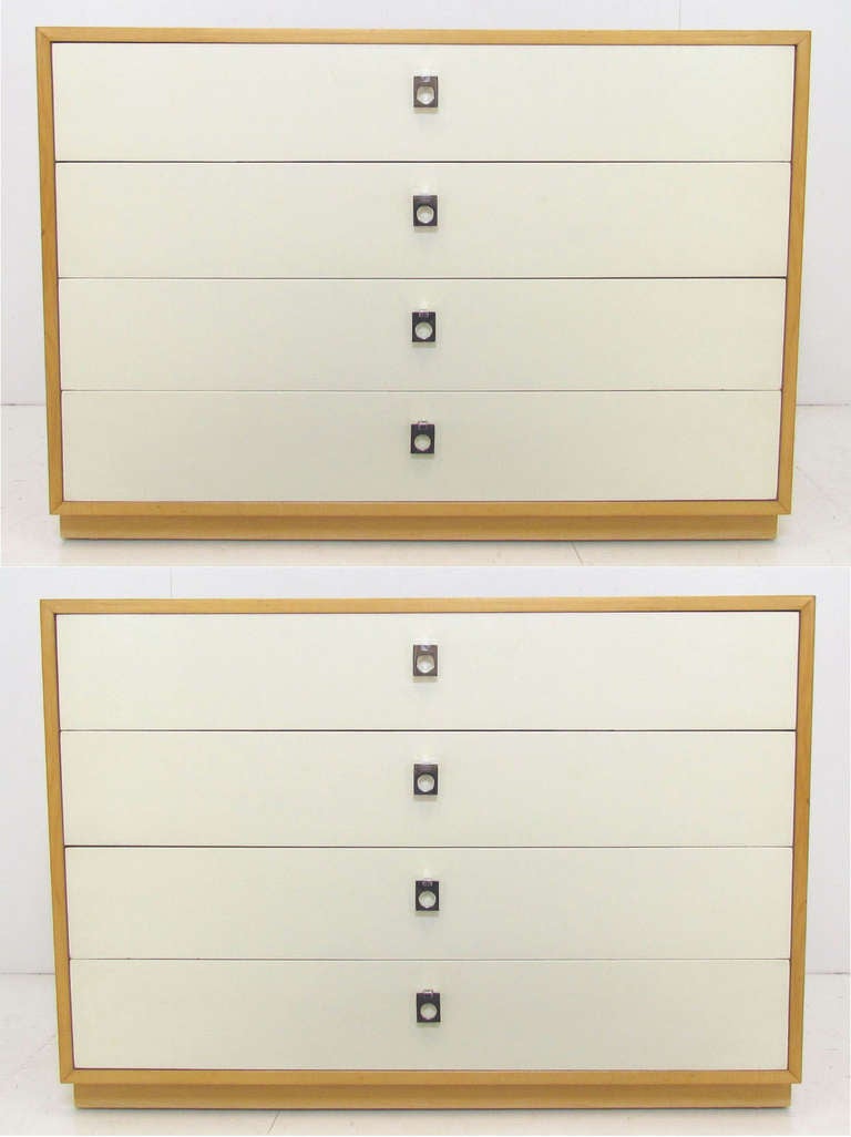 Pair of modernist chest of drawers by Founders, ca. 1960s.  Birch frames with cream-colored lacquered drawer fronts and chrome pulls.